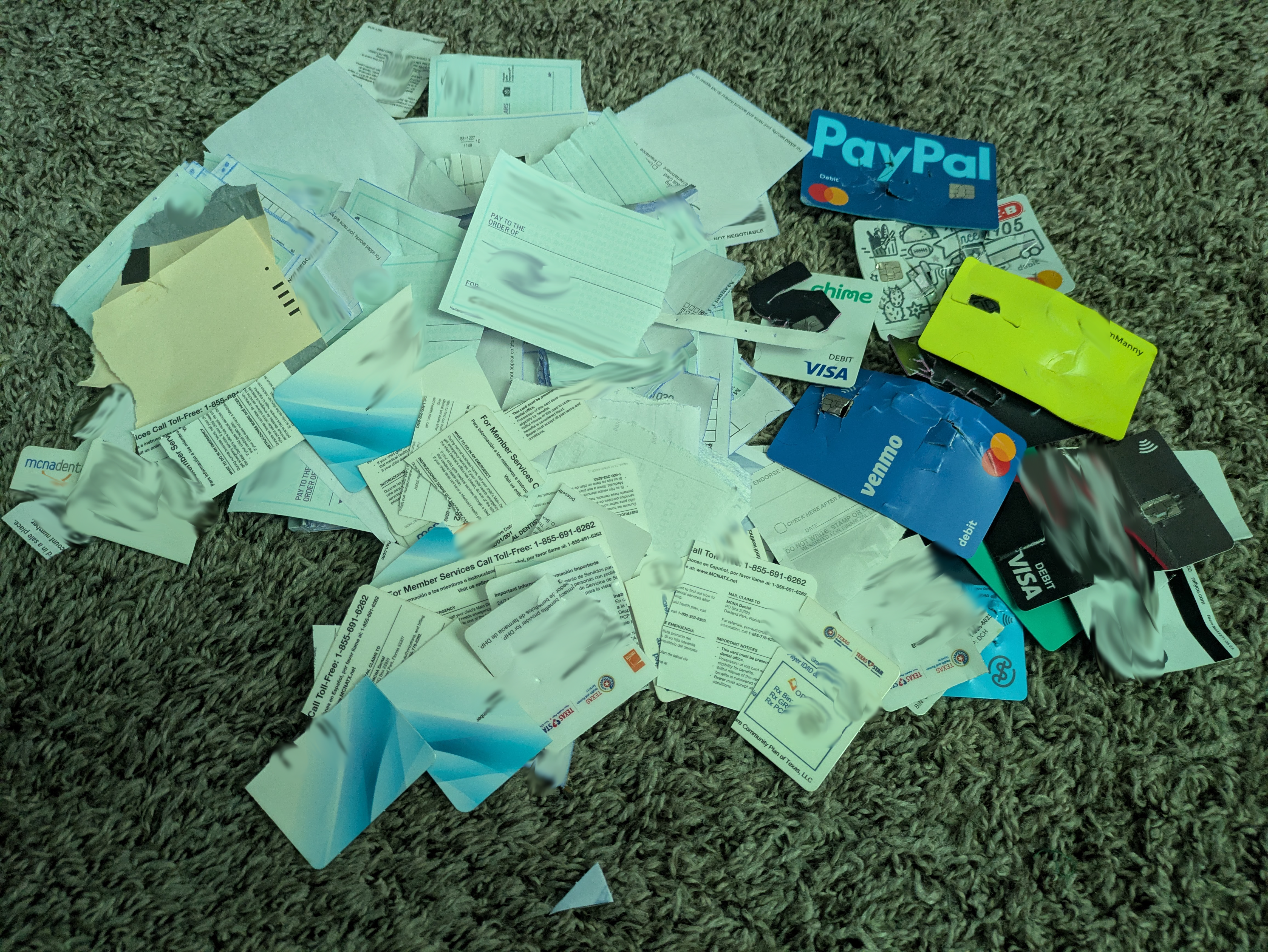 Pile of broken payment cards, destroyed health cards, torn checkbooks