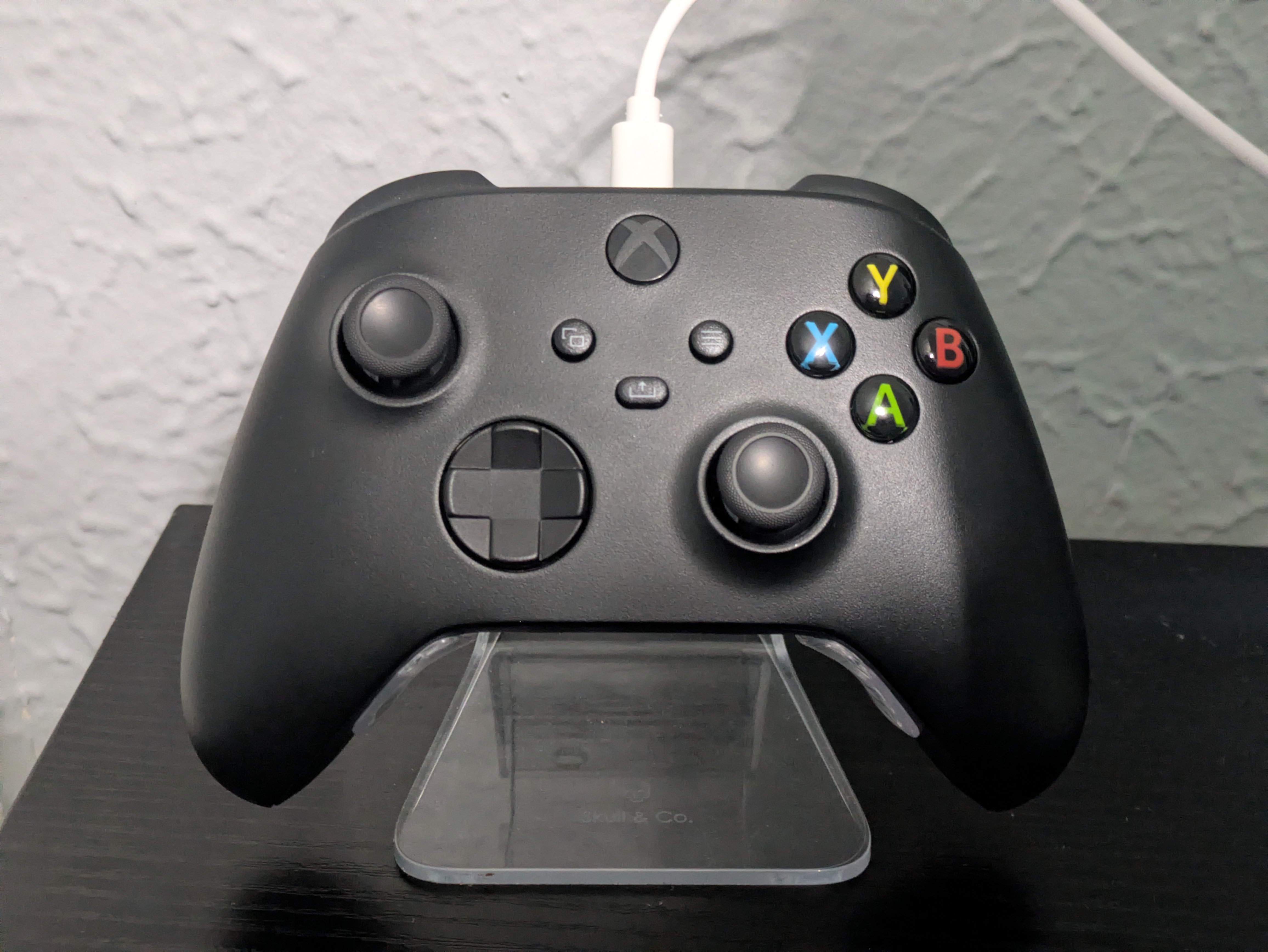Xbox Series controller in a clear plastic stand