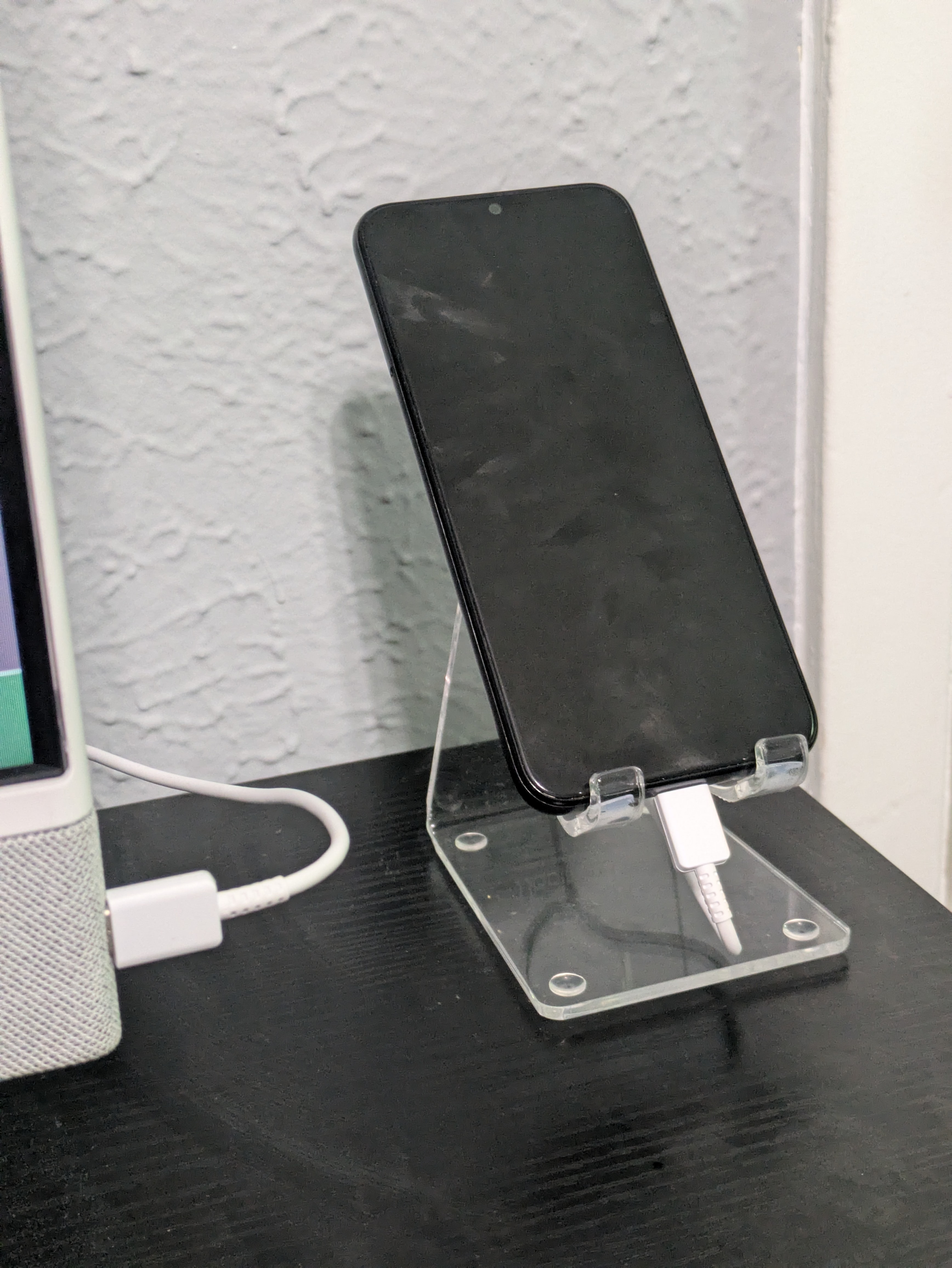 Android phone in a clear plastic stand
